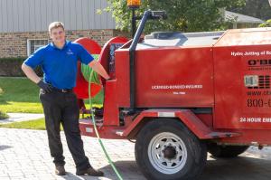 J. Blanton Plumbing technician smiling and wearing a company uniform, symbolizing the company's sponsorship of the End Hunger Games 2024 and highlighting their 24-hour plumbing service, drain camera inspections, and expertise in fixing water heaters.