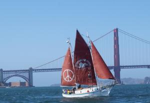 The Golden Rule peace boat sails by the Golden Gate Bridge