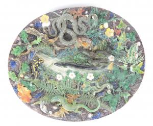 18 ¾ inch by 16 inch Charles Avisseau majolica Palissy Art of the Earth dish, circa 1865, the oval basin profusely covered in fauna, leaves, etc. (est. $8,000-$12,000).