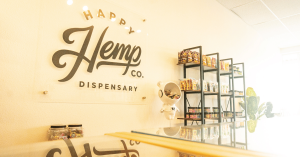 Interior view of Happy Hemp Co. Dispensary, showcasing a clean, modern layout with shelves stocked with a variety of hemp products and edibles.