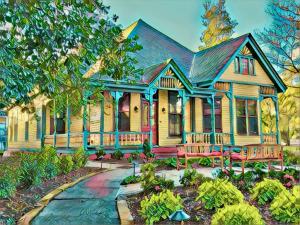 Lovely yellow house with porches, sitting areas, and beautiful gardens comprise the look of Cumberland Crest House.