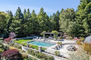 Luxurious outdoor living space with a kitchen and heated saltwater pool