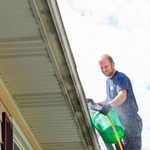 man cleaning gutter