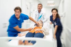 Medical staff rushing patient to emergency room