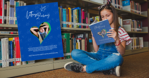 girl in library sitting on floor read letters to zachary book