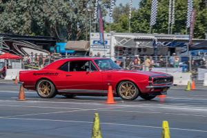 a vintage Camaro racing around the autocross track