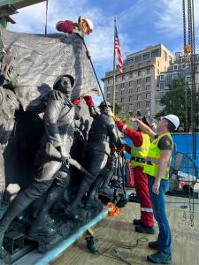 Master Sculptor Sabin Howard points to Flag placement