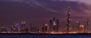 image of Dubai at night with lit up buildings