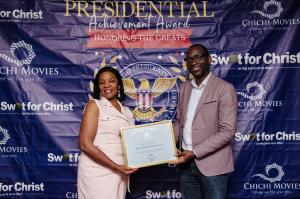 Amb. Dr. Mrs. Catherine Agionomoisi Utsalo receives the President’s Volunteer Service Award