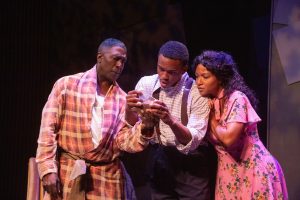 In a scene from the stage play "The Double V" are actors Idrees Degas (Clem), K.J. Powell (James Thompson), and Nicolette Ellis (Annie Culver). Photo Credit: Kayte Deioma.