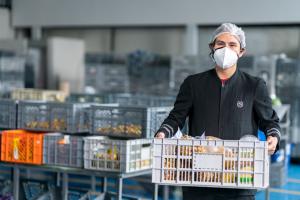 Photo shows a worker carrying donated food at a food bank in Quito, where the methodology was piloted.