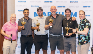 Group photo of the winning team for the best score at the 2024 Markham Board of Trade Corporate Charity Golf Classic. Six men stand in front of an MBT backdrop with trophies. On the left is Paul Teitelman from BDO Canada, and on the right is MBT President Chris Colucci.