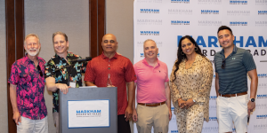 A group photo of the MBOT Board of Directors at the 2024 Corporate Charity Golf Classic. From left: Ron Minken, Chris Colucci, Sam Erry, Paul Teitelman, Rajinder Minhas, and Tim Keung, standing in front of an MBT backdrop