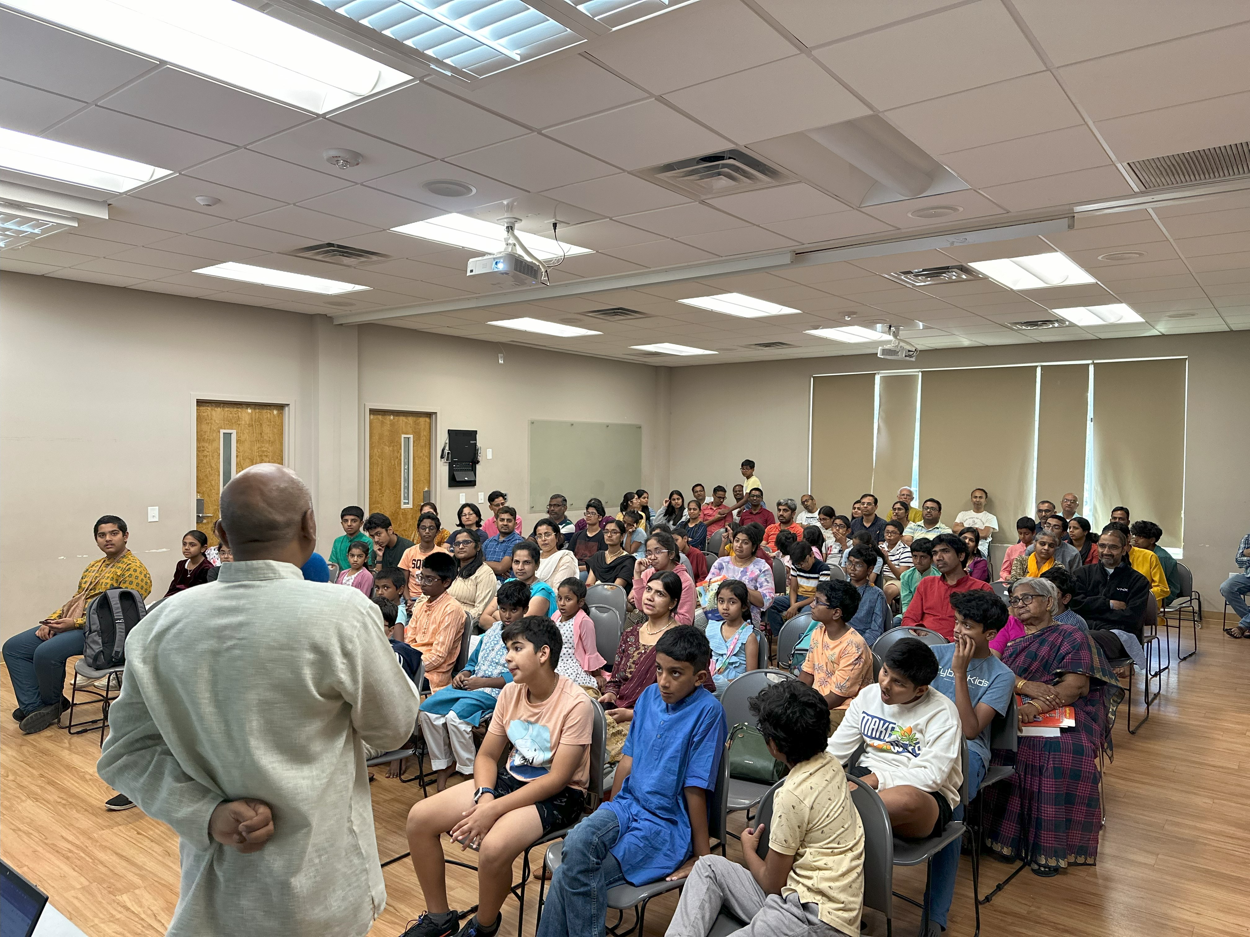 Shri Aravind Swami, VP of Operations gives a presentation about Hindu University of America to a large audience.