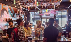 A group of patrons enjoying sake and cocktails in the afternoon inside the colorado sake  co.  taproom