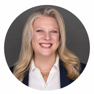 Image of Andrea D. Carter wearing a blue suit jacket and white collared shirt. Andrea has shoulder length blonde hair and is smiling.