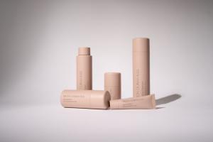 A collection of Simon Ourian M.D. skincare products including a Gel Hydrator, Toner, Cleanser, and Eye Complex, displayed against a soft, minimalist background. The packaging is sleek and elegant, showcasing the brand's commitment to personalized skincare