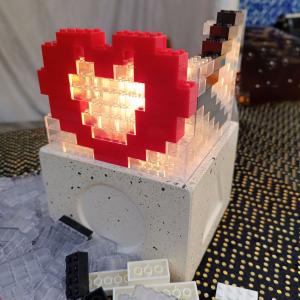 Red heart made with play bricks on Lampadabra luminaire