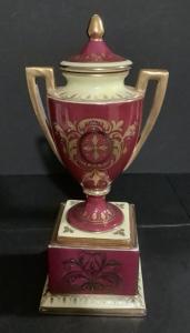 Royal Vienna hand-painted vase (or urn) showing the maker’s mark and measuring just shy of 8 inches tall and 3 ¾ inches wide (est. $250-$500).