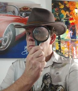 Head puzzle creator David Steele of The Great US Treasure Hunt, holding a magnifying glass to indicate looking for clues