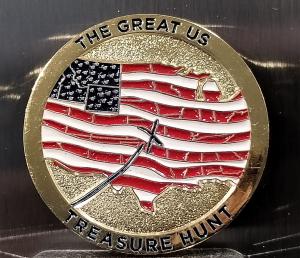 A sample Great US Treasure Hunt coin, ten of which will be hidden for the hunt. The coin is metal, with an American flag logo