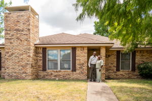 Sgt. Kevin Jones and his wife, Francesca in front of their Duncanville Home