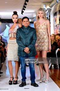 Designer Prashant Goyal posing with models Gabby Lana and Morgan Sullivan at the International Heritage Fashion Show