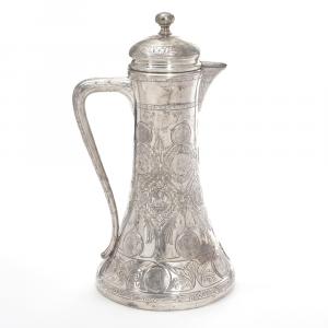 Late 19th century German tankard by Carl Frey & Sohne (Breslau), 20 inches tall, weighing 90.1 ozt., with a squat base and hinged lid mounting 27 antique silver coins (est. $3,000-$5,000).