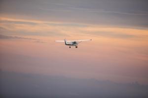 Cessna 172 flying at sunset