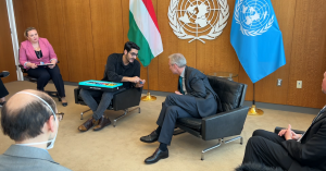 Twin Science Co-Founder Cihan Özalevli demonstrating a STEM kit to the President of the United Nations at the UN Headquarters. Cihan, seated on the left, is holding and explaining the kit to the UN President, who is attentively listening. Both are seated 