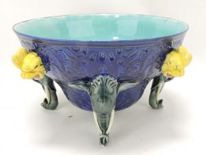 Wedgwood majolica cobalt elephant punch bowl with the bowl being supported by 4 elephants as feet, and four grotesque mask handles, 6 ½ inches tall, 12 inches wide (est. $2,000-$3,000).