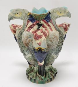 1876 Copeland majolica memorial vase, 10 inches tall, retailed by J.M. Shaw & Co. (NYC) in the form of three back-to-back eagles guarding the American flag (est. $6,000-$9,000).