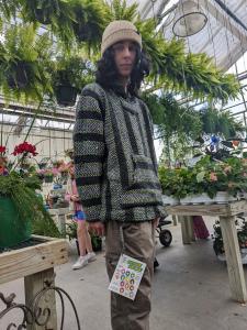 A guy stands in the flower shop with his Action Aroma kit hanging by a chain from his pocket for quick, easy access.