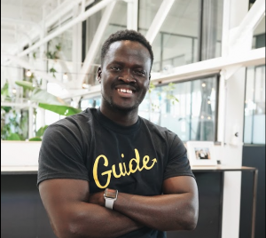 Taban smiling while wearing a vintage Guide T-Shirt that says "Guide" on it