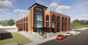 A rendering of a three story brick building. The front has a large square glass atrium that extends all three stories. Each side of the building has tall windows that are rounded at the top. There is green space to the left of the front door and parked cars