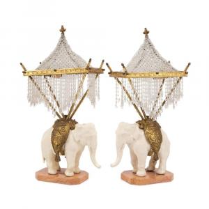 Pair of French mid-20th century bronze chinoiserie porcelain blanc de chine elephant table lamps boasting a beaded palanquin shade, gilt bronze howdah and a pink marble base ($7,260).