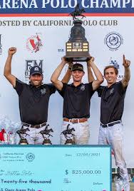 three arena polo players from Texas raise the U.S Open Arena Polo Championship trophy