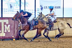 An arena polo player shoots on goal under the U.S. Polo Assn. banner