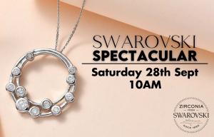 Silver necklace with Swarovski Zirconia stones displayed on a light peach background. Text reads "Swarovski Spectacular, Saturday 28th Sept, 10 AM," with the Swarovski Zirconia logo in the corner.