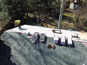 This is an image of Four Seasons team members working on a roof.