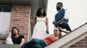 Mr. FoW and two women sit on a rooftop, with the figures looking off into the distance or toward the camera in a reflective mood.