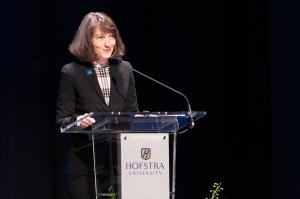 Hofstra President Susan Poser standing at podium delivering State of University Address