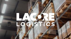 Blurred background of a warehouse with shelves stocked with boxes, prominently featuring the 'LaCore Logistics' logo in the foreground, highlighting their role in logistics and community support efforts