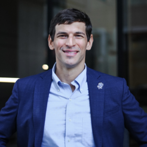 30-something white man smiling at camera