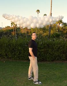 Sean Edwards, Founder of The Balloon Guy posing with Balloon Garland