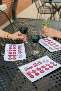 Westport wine tastings at eleven different establishments shows complimentary glasses at a table on an outside patio.
