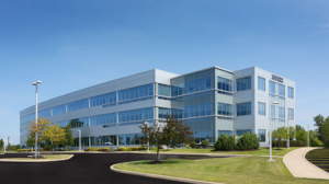 Commercial building with blue sky and empty parking lot