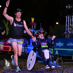 Brent and Kyle Pease cross the finish line at the 2024 Disney Marathon Weekend - one of more than 125 races they've completed together. Kyle has cerebral palsy and is pulled, pedaled and pushed through race events by his brother Brent.