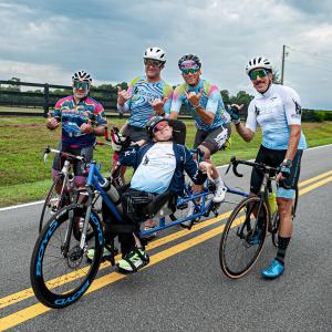 Brent and Kyle Pease, along with other KPF teammates, stop for a photo during one of their IRONMAN training rides.