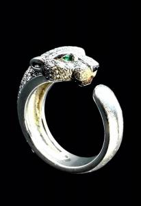 Panthère de Cartier 18k white gold diamond and emerald ring in the form of a panther, set with pave diamonds, inset emerald eyes and black onyx nose, marked (est.$4,000-$6,000).